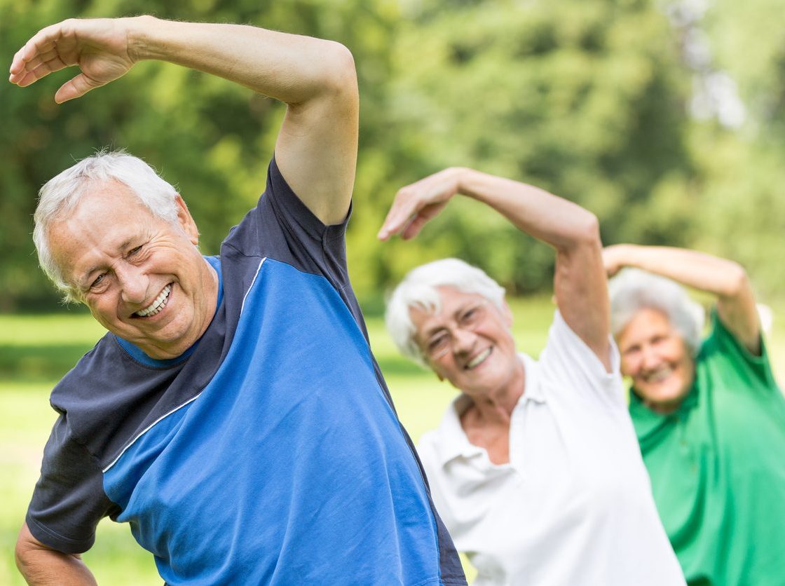 Group of senior adults doing physical exercise outdoors